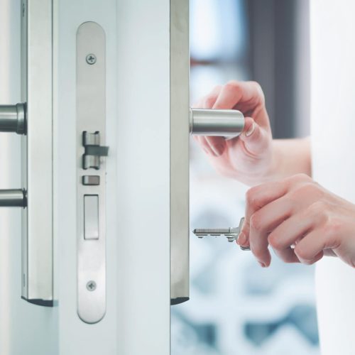locking-or-unlocking-door-with-key-in-hand-2021-08-30-08-20-10-utc